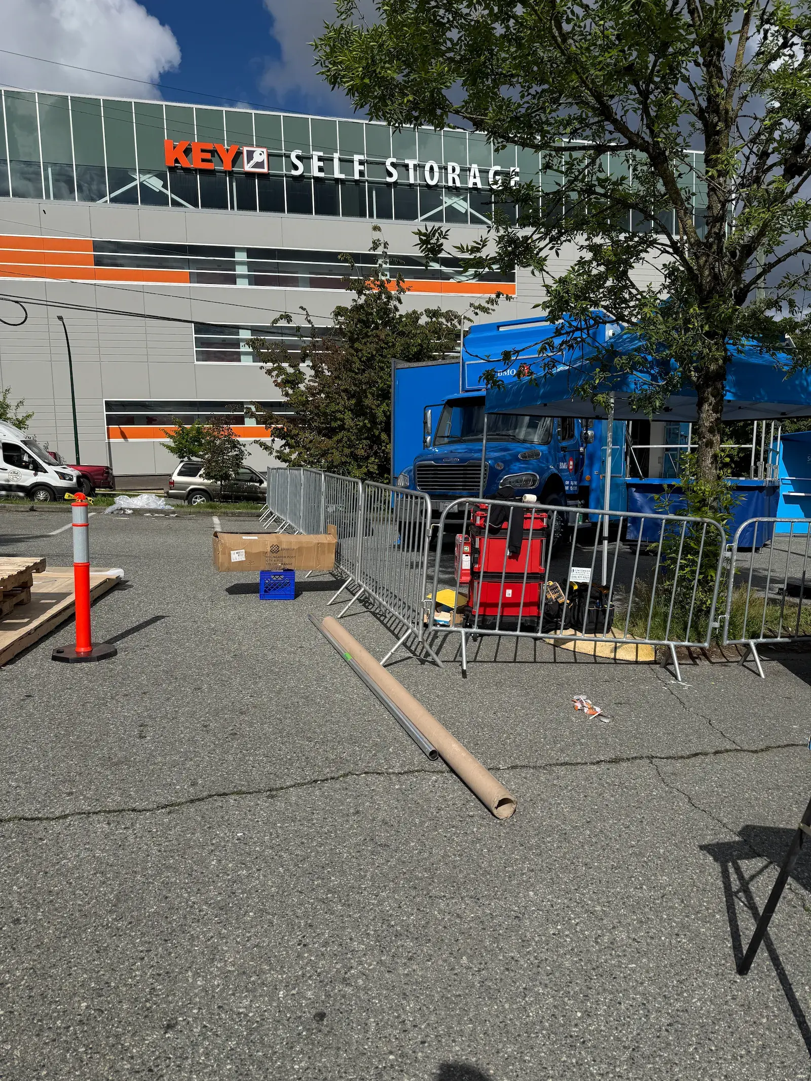 Crowd control barriers staged in a parking lot ahead of an event build.