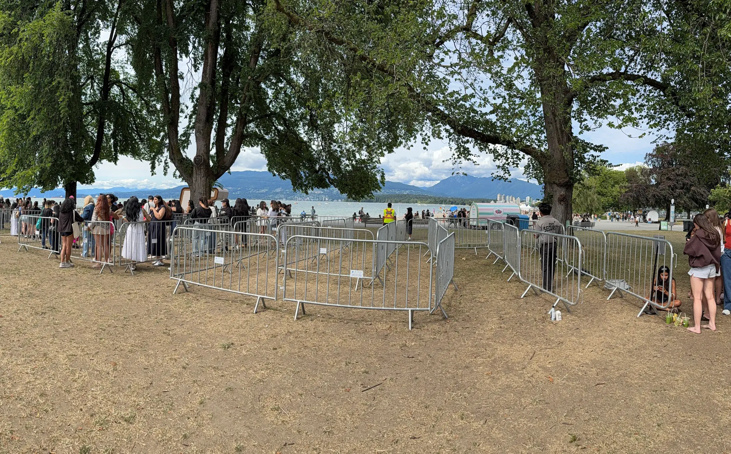 Galvanized steel crowd control barriers set up in a line at an outdoor event in Vancouver.